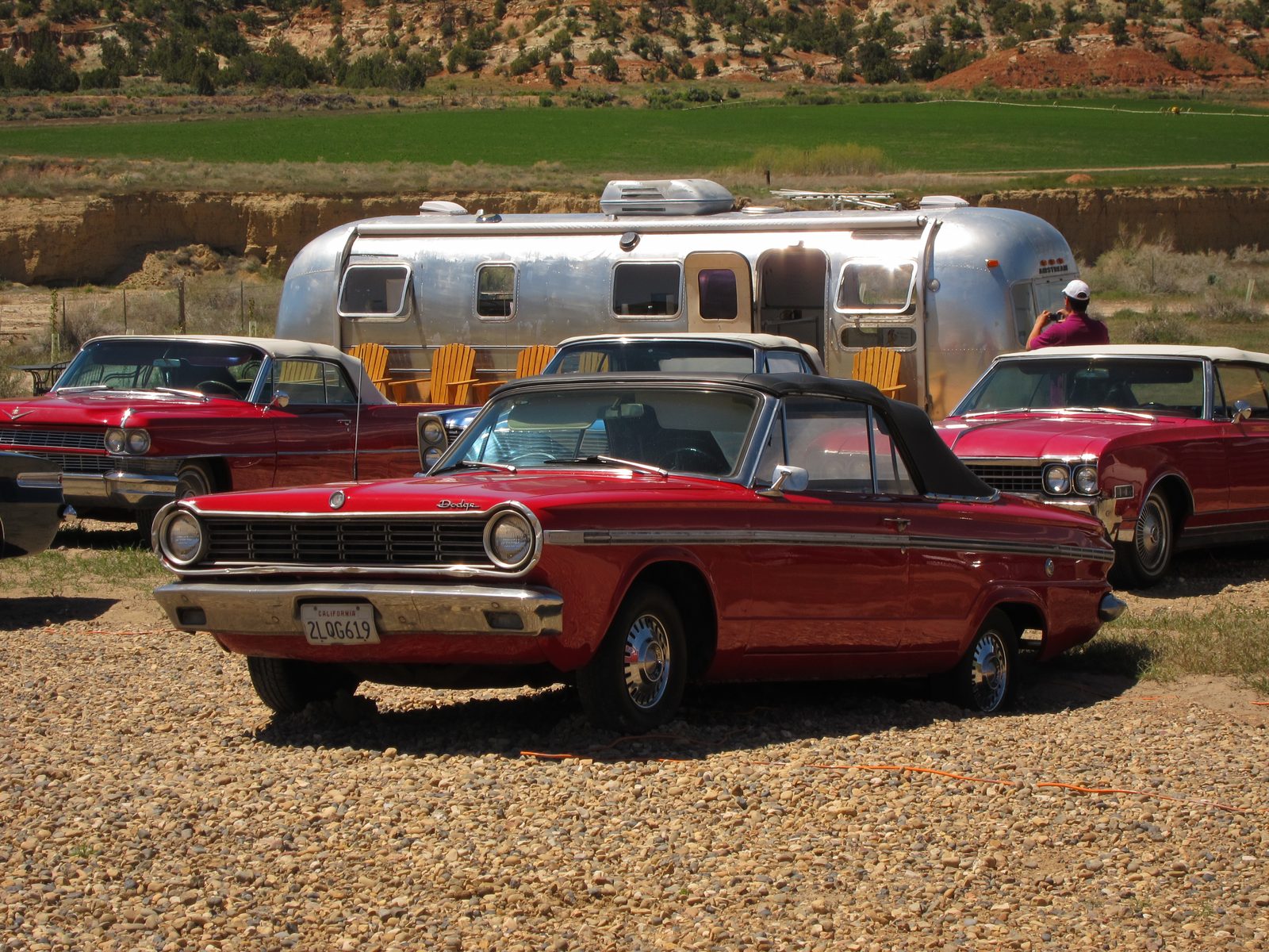 More cars and the refreshment stand being photographed.